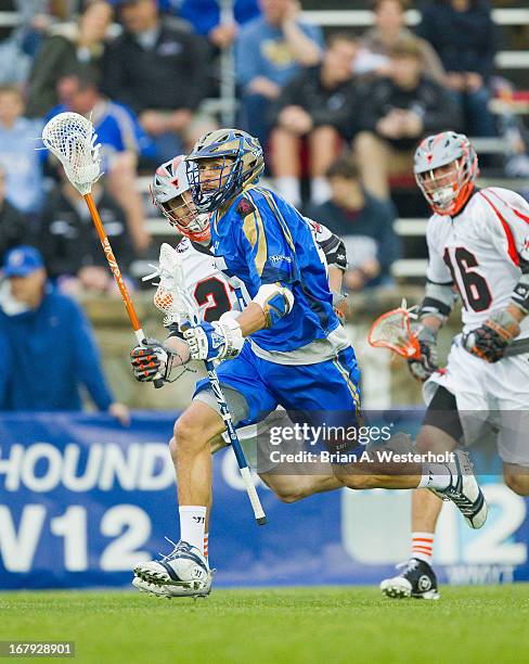 Casey Cittadino of the Charlotte Hounds carries the ball up the field during first half action against the Denver Outlaws at American Legion Memorial...