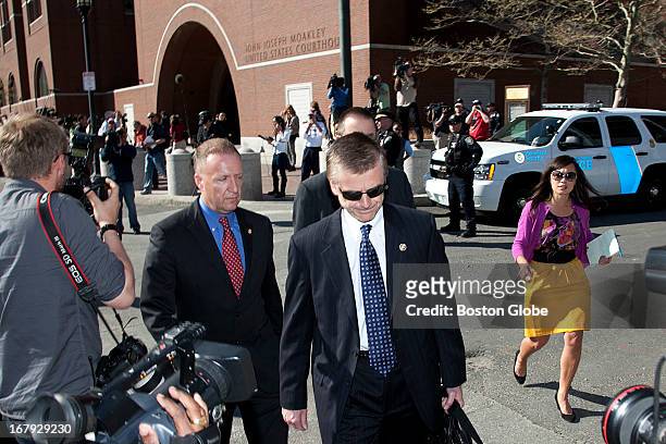 Special Agent in Charge Richard DesLauriers, center, walks with other FBI agents out of the courthouse. Two men from Kazakhstan and a man from...