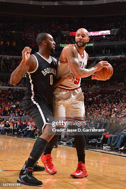 Carlos Boozer of the Chicago Bulls looks to pass the ball against the Brooklyn Nets in Game Three of the Eastern Conference Quarterfinals during the...