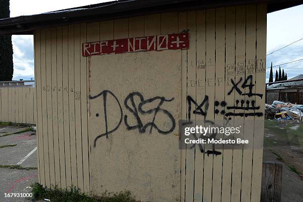 An alley shows where gang graffiti is visible in south Modesto California, March 6, 2013.