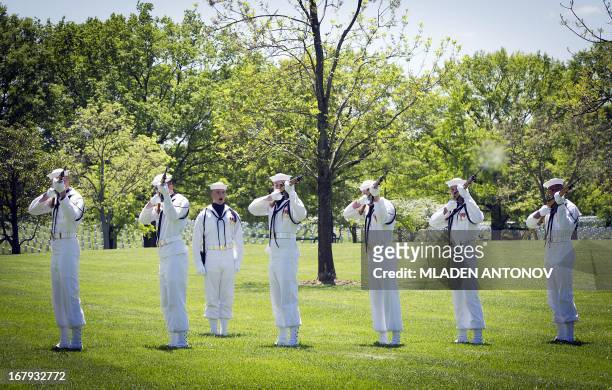 Firing squad renders salute for the four missing US Navy Sailors from the Vietnam War during a burial service at Arlington National Cemetery, May 02,...