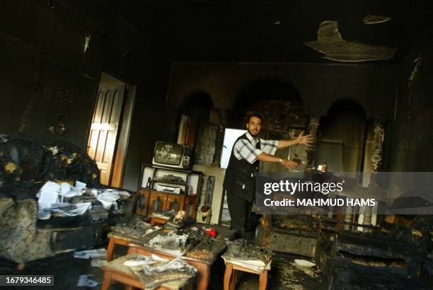 Palestinian researcher inspects his burnt office in the Arabic Strategy Researches Center which supports the Hamas movement after clashes with...