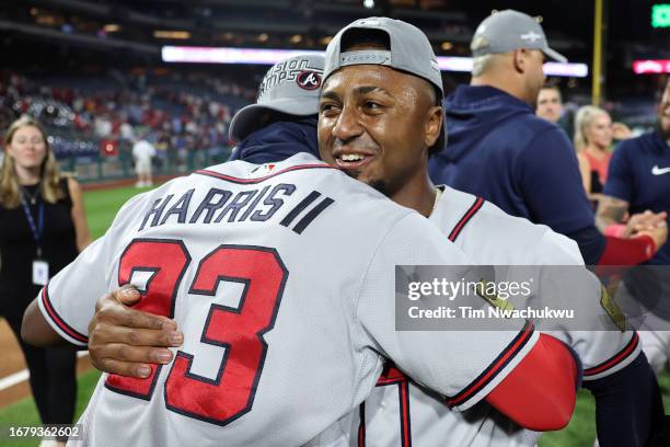 Michael Harris II and Ozzie Albies of the Atlanta Braves react after defeating the Philadelphia Phillies to clinch the NL East at Citizens Bank Park...