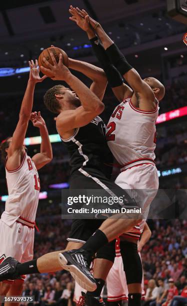 Taj Gibson of the Chicago Bulls fouls Brook Lopez of the Brooklyn Nets in Game Six of the Eastern Conference Quarterfinals during the 2013 NBA...