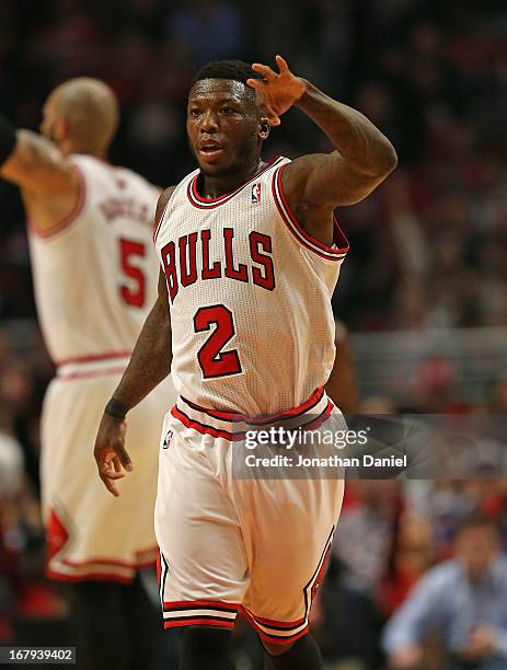 Nate Robinson of the Chicago Bulls holds up 3 fingers after hitting a three point shot against the Brooklyn Nets in Game Six of the Eastern...