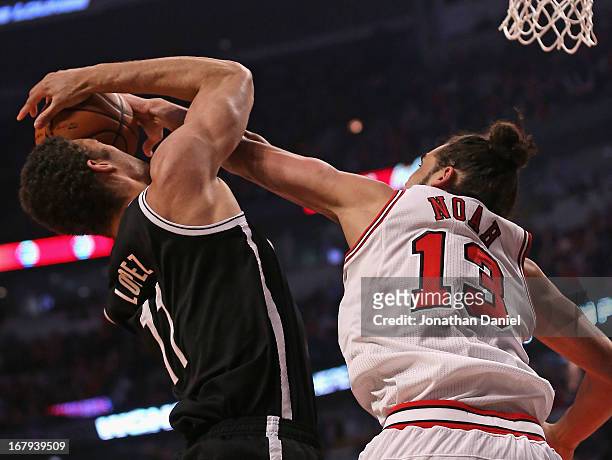 Joakim Noah of the Chicago Bulls stuffs Brook Lopez of the Brooklyn Nets to force a jump ball in Game Six of the Eastern Conference Quarterfinals...
