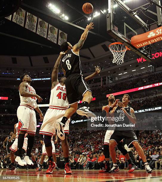 Deron Williams of the Brooklyn Nets shoots over Nazr Mohammed of the Chicago Bulls in Game Six of the Eastern Conference Quarterfinals during the...