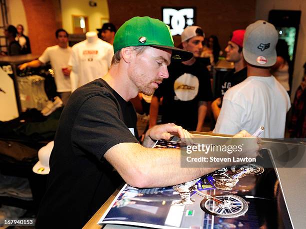 Motorcross rider Nate Adams signs autographs during a DC Moto Team appearance in celebration of the 2013 AMA Supercross Finals at the DC Shoes store...