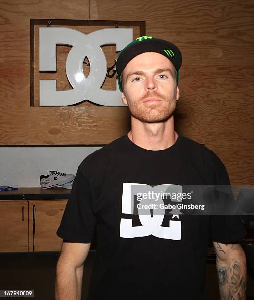 Motorcross rider Nate Adams poses before he signs autographs during a DC Moto Team appearance in celebration of the 2013 AMA Supercross Finals at the...