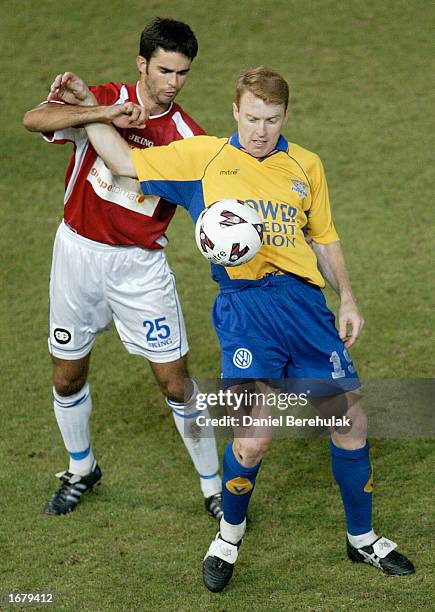 Brendan Renaud of the Power is tackled by Ante Deur of United during the NSL round 12 match between Parramatta Power and Sydney United at Parramatta...