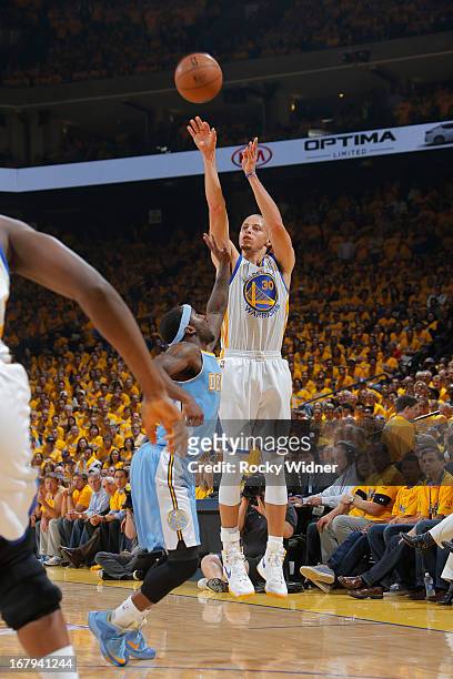 Stephen Curry of the Golden State Warriors shoots against Ty Lawson of the Denver Nuggets in Game Six of the Western Conference Quarterfinals during...