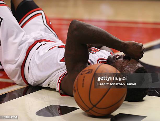 Nate Robinson of the Chicago Bulls lays on the floor after being fouled while driving to the basket against the Brooklyn Nets in Game Six of the...