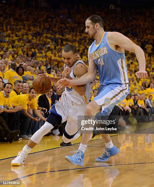 Stephen Curry of the Golden State Warriors drives on Kosta Koufos of the Denver Nuggets during the thrid quarter in Game 6 of the first round NBA...