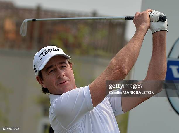 Brett Rumford of Australia tees off at the 7th hole before finishing at 9 under par on the second day of the Volvo China Open golf tournament at the...