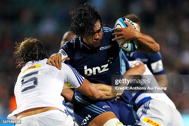 Steven Luatua of the Blues charges into Andries Bekker of the Stormers during the round 12 Super Rugby match between the Blues and the Stormers at...