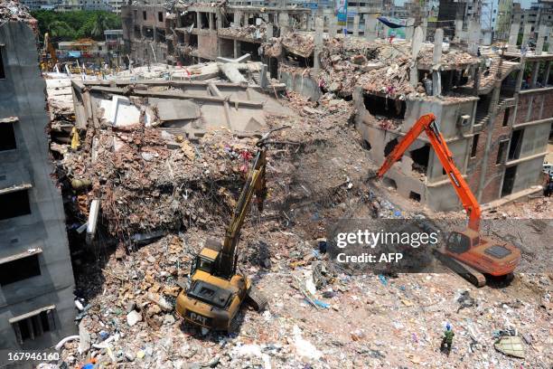 Bangladeshi rescuers use diggers to move debris as Bangladeshi Army personel continue the second phase of a rescue operation using heavy equipment...