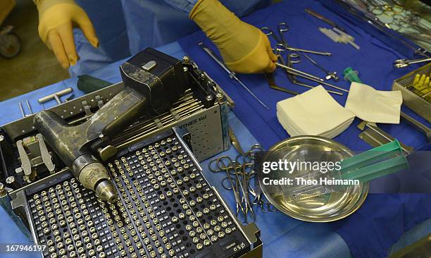 Medical instruments, including an electric drill, lie on a table as a horse undergoes surgery on a fractured leg at the Dueppel animal clinic on...