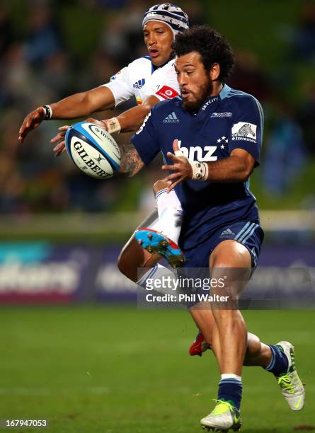 Rene Ranger of the Blues and Gio Aplon of the Stormers contest the ball during the round 12 Super Rugby match between the Blues and the Stormers at...