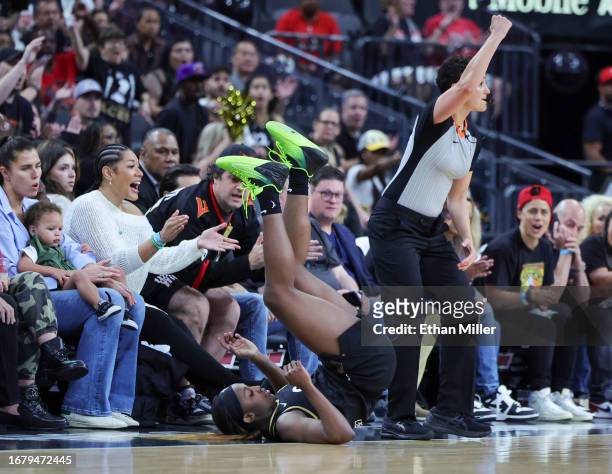 Jackie Young of the Las Vegas Aces falls backward after hitting a 3-pointer and drawing a foul against the Chicago Sky in the second quarter of Game...