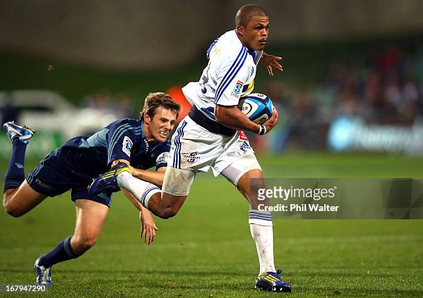 Juan De Jongh of the Stormers is tackled by Chris Noakes of the Blues during the round 12 Super Rugby match between the Blues and the Stormers at...