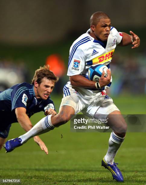 Juan De Jongh of the Stormers is tackled by Chris Noakes of the Blues during the round 12 Super Rugby match between the Blues and the Stormers at...