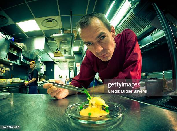French chef David Faure poses with a start dish of 'Petit pois carre et son ecume de Carottes, vers de farine' - peas, carrots and worms - as he...