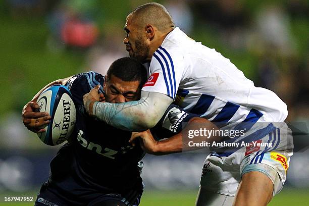 Charles Piutau of the Blues is tackled by Bryan Habana of the Stormers during the round 12 Super Rugby match between the Blues and the Stormers at...