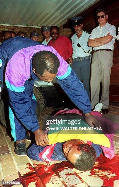 South African Communist Party leader Chris Hani lies dead in front of his home 10 April 1993. Hani reportedly was shot four times in the driveway of...