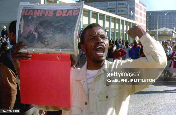An African National Congress supporter holds a picture 13 April 1993 of Chris Hani, the South African Communist Party leader who was killed 10 April....