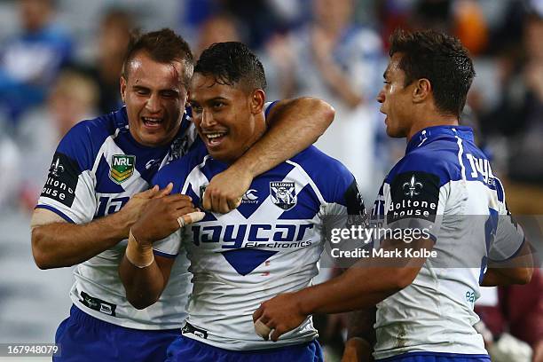 Josh Reynolds and Ben Barba of the Bulldogs celebrate after Sam Perrett of the Bulldogs scored a try during the round eight NRL match between the...