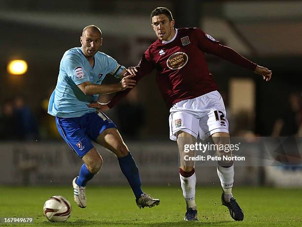 Ben Tozer of Northampton Town looks for the ball with Russell Penn of Cheltenham Town during the npower League Two Play Off Semi Final 1st leg match...