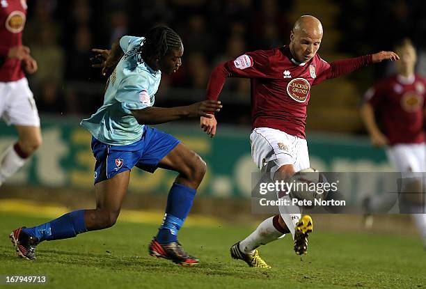 Luke Guttridge of Northampton Town attempts to control the ball under pressure from Jermaine McGlashan of Cheltenham Town during the npower League...
