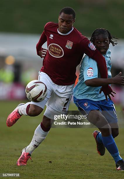 Ishmel Demontagnac of Northampton Town attempts to control the ball under pressure from Jermaine McGlashan of Cheltenham Town during the npower...
