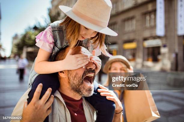 young caucasian family shopping in the city - family mall stockfoto's en -beelden