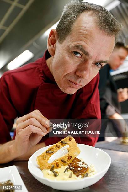 By CELINE AGNIEL - FILES French Michelin-starred Chef David Faure holds a cricket as he poses in front of a dish "Cremeux de mais, foie gras poele"...