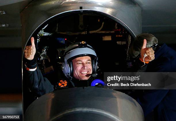 Pilot Bertrand Piccard gives a thumbs up before taking off in the Solar Impulse solar electric airplane at Moffett Field on May 3, 2013 in Mountain...