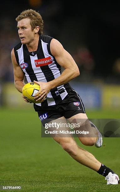 Sam Dwyer of the Magpies runs with the ball during the round six AFL match between the Collingwood Magpies and the St Kilda Saints at Etihad Stadium...