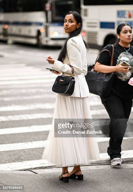 Guest is seen wearing a white blazer, white tule skirt and black bag outside the Willy Chavarria show during NYFW S/S 2024 on September 13, 2023 in...