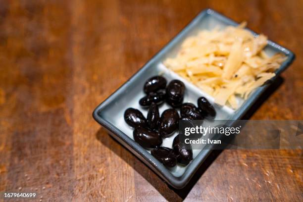 japanese side dish, black bean and pickled bamboo - takuan stockfoto's en -beelden