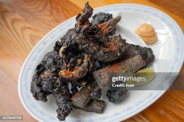 deep fried seafood with squid, cuttle ink black batter - deep fried bildbanksfoton och bilder