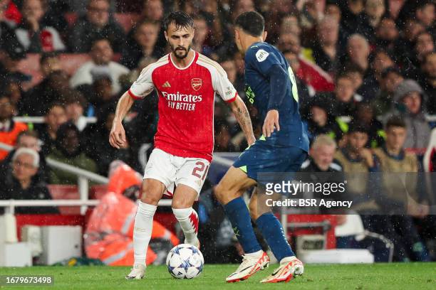 Fabio Vieira of Arsenal is challenged by Sergino Dest of PSV during the UEFA Champions League Group B match between Arsenal and PSV at Emirates...