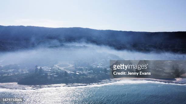 In an aerial view, smoke haze is seen along the coastline on September 14, 2023 in Wollongong, Australia. The smoke haze is a result of a number of...