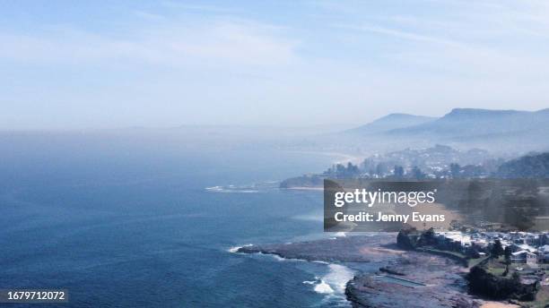 In an aerial view, smoke haze is seen along the coastline on September 14, 2023 in Wollongong, Australia. The smoke haze is a result of a number of...