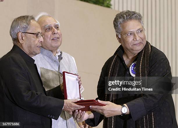 President Pranab Mukherjee presenting best actor award to Vikram Gokhale for performance in Marathi film Anumati during 60th National Film Awards on...