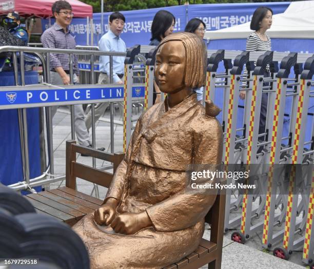 Photo taken on Sept. 21 shows a statue symbolizing "comfort women," forced to work in Japanese wartime military brothels, in front of the Japanese...