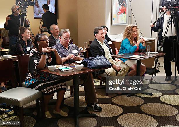 Guests watch a cooking demonstration conducted by award recipient, chef and lifestyle entrepreneur Cat Cora at the 2013 Resident Mom of the Year...