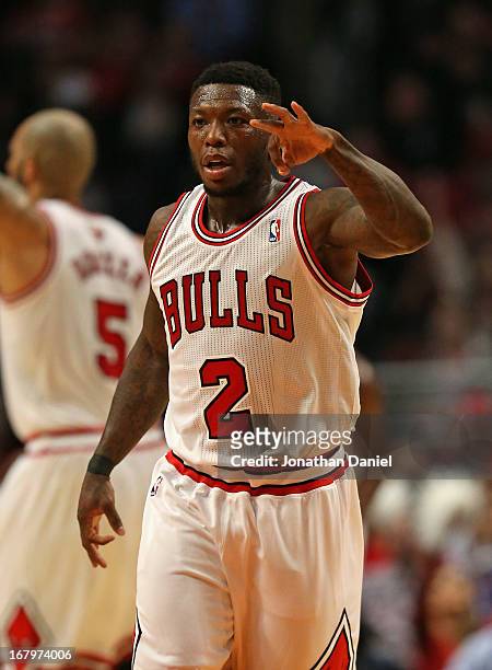 Nate Robinson of the Chicago Bulls holds up 3 fingers after hitting a three point shot against the Brooklyn Nets in Game Six of the Eastern...