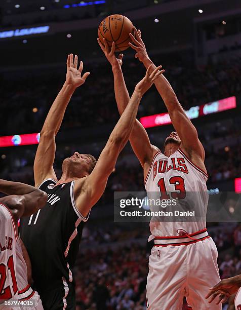 Joakim Noah of the Chicago Bulls grabs a rebound away from Brook Lopez of the Brooklyn Nets in Game Six of the Eastern Conference Quarterfinals...
