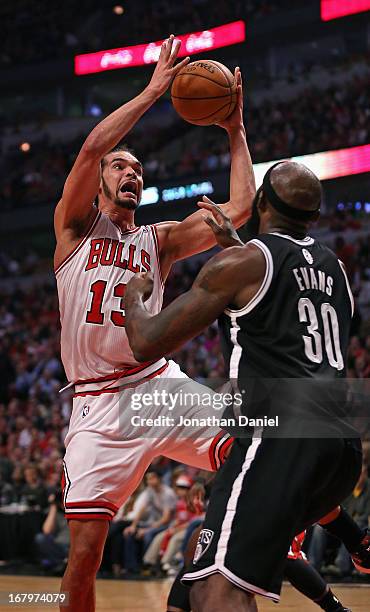 Joakim Noah of the Chicago Bulls rebounds over Reggie Evans of the Brooklyn Nets in Game Six of the Eastern Conference Quarterfinals during the 2013...