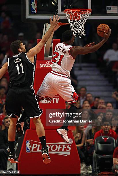 Jimmy Butler of the Chicago Bulls shoots past Brook Lopez of the Brooklyn Nets in Game Six of the Eastern Conference Quarterfinals during the 2013...